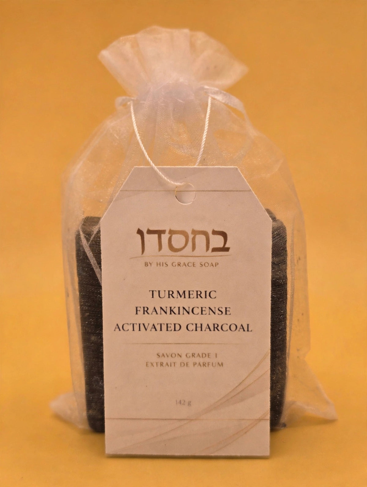 Turmeric Frankincense Activated Charcoal Soap Bar on a gold background, main photo